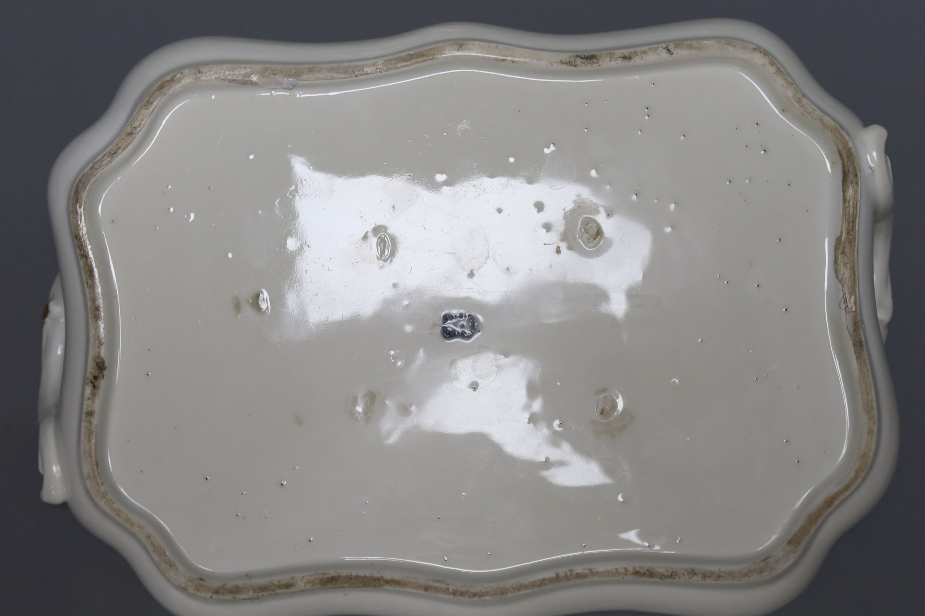 Two 18th century Vienna porcelain trays and a seated figure, largest tray 16cm